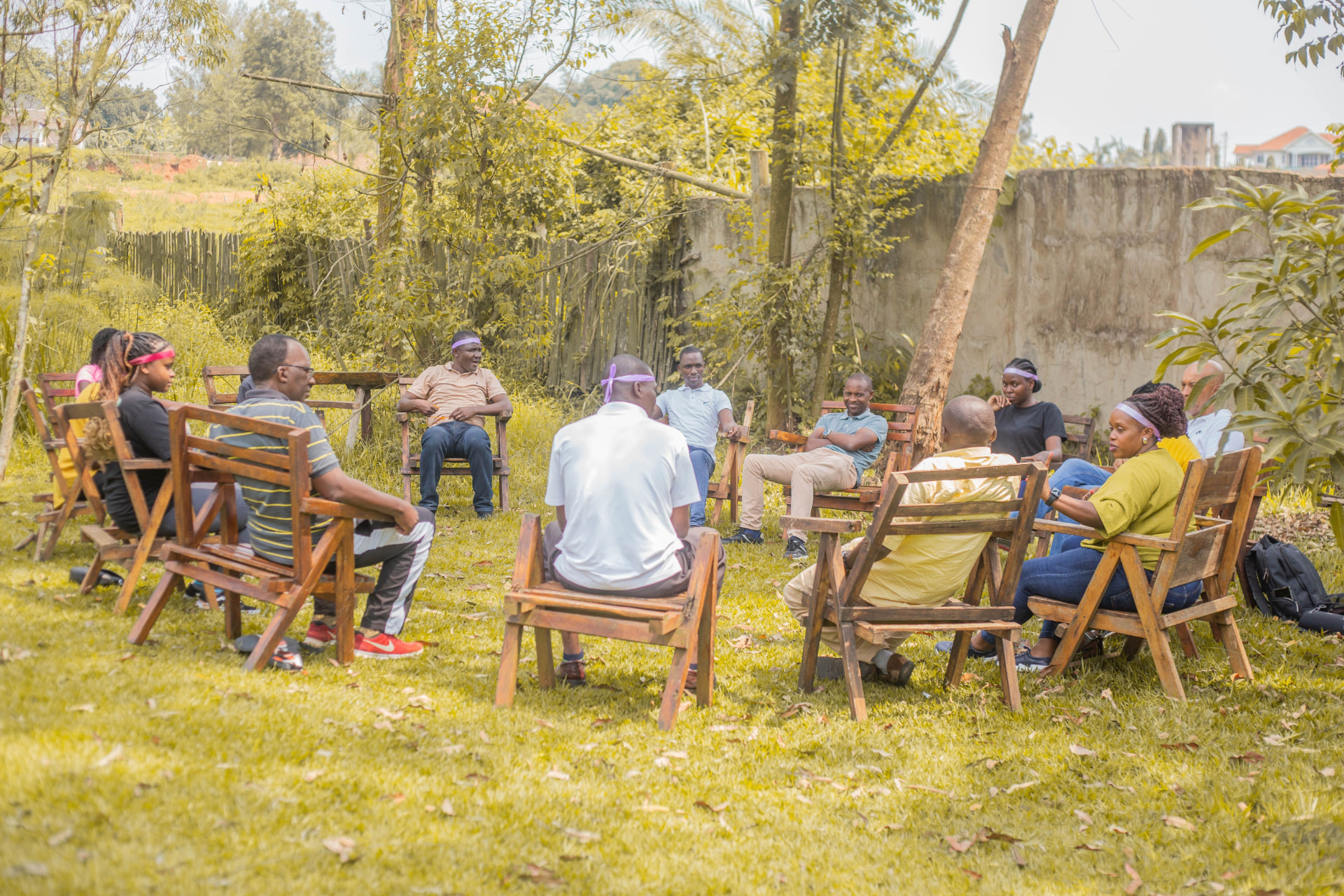 Retreat leaders seated in a circle outdoors for an intimate roundtable discussion