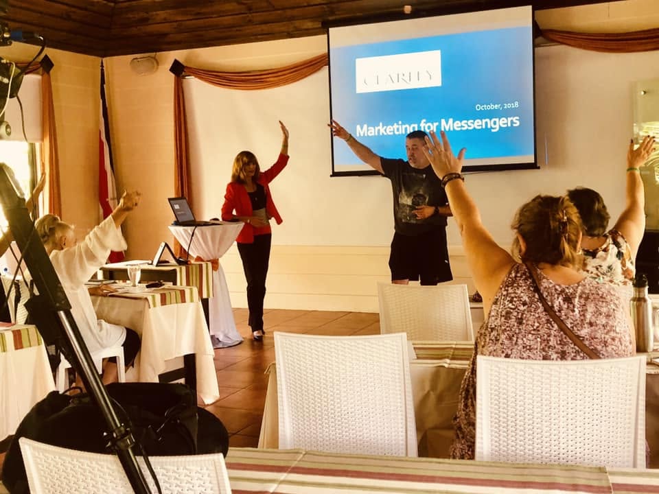 Travis Richardson leading an interactive workshop with participants raising their hands