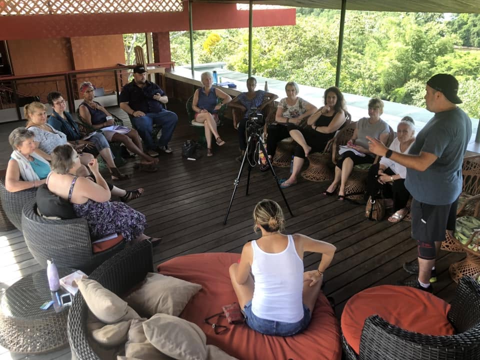 Travis Richardson leading an intimate group integration circle on a Costa Rica villa deck
